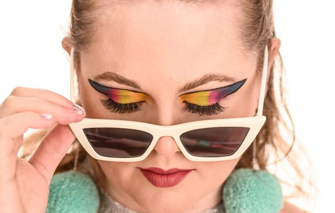 Woman looking down through sunglasses  - Professional Makeup Artist | TV & Film | Winnipeg, Manitoba